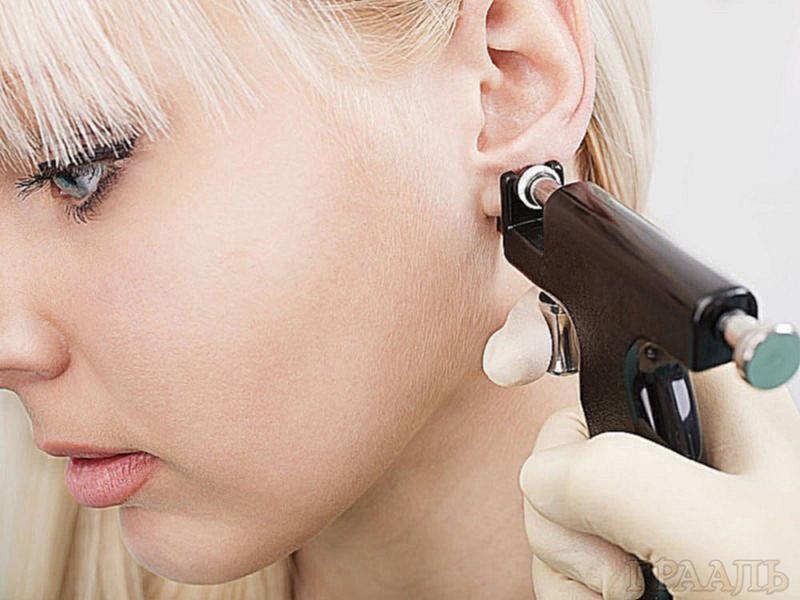 Ear piercing at the Grail salon